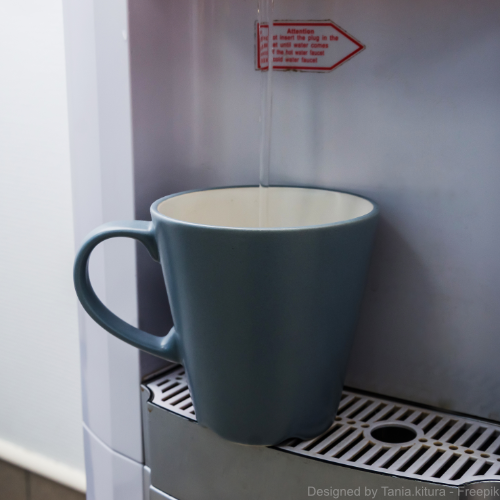 Eine Tasse wird mit Wasser aus einem leitungsgebundenen Wasserspender befüllt